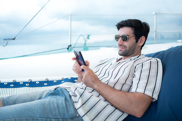 istock A young man is enjoying his seaside adventure aboard a yacht 2216591250