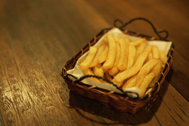 French fries are arranged in a basket.