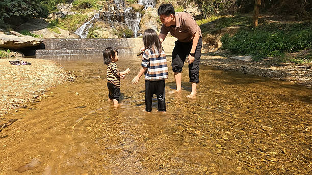 istock A family having fun by the waterfall. 2216596617