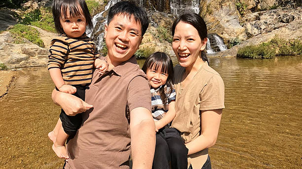 istock A family having fun by the waterfall. 2216596621