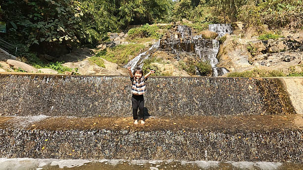 a group of people having fun at the waterfall.