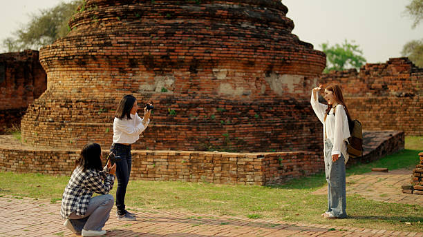 Asian women travelers traveling in a group in Ayuthaya, Thailand.