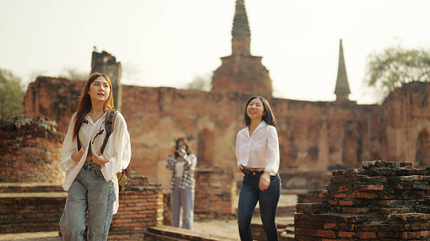 Asian women travelers traveling in a group in Ayuthaya, Thailand.