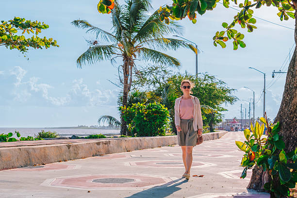 istock Woman walking along seawall in Georgetown, Guyana 2216599645