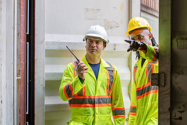 istock Workers man team inspecting containers box at shipping container cargo, Engineer and foreman working in industry containers yard 2216601689