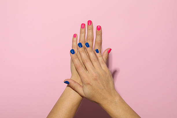 istock Blue and pink manicure on female hands 2216602588