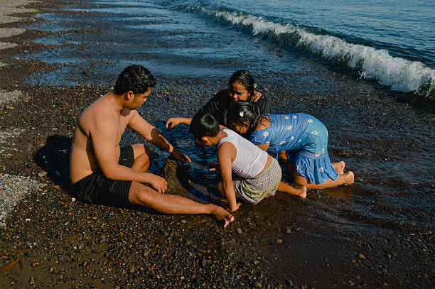 istock Family joins in adding drips to sand creation together 2216605246
