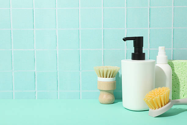 istock Dispenser for soap, brushes, sponge and bottles on blue background, space for text 2216606855