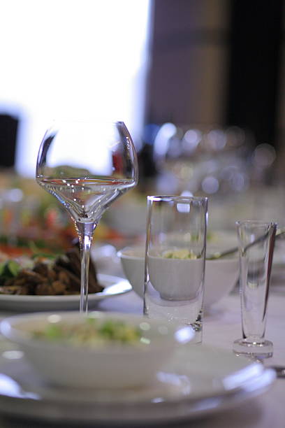 istock Elegant dining table setup with glassware and bowls in soft focus 2216607522