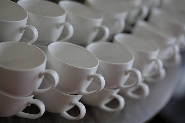istock Neatly stacked white porcelain coffee cups in rows 2216607540