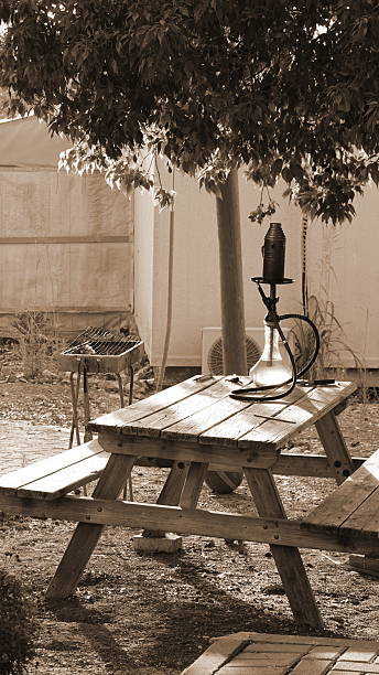 istock Hookah Rustic Table Sepia Vertical Outdoor Relaxing Scene Nature Shadows 2216607689