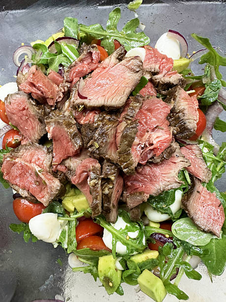 Juicy grilled steak salad with fresh vegetables and greens