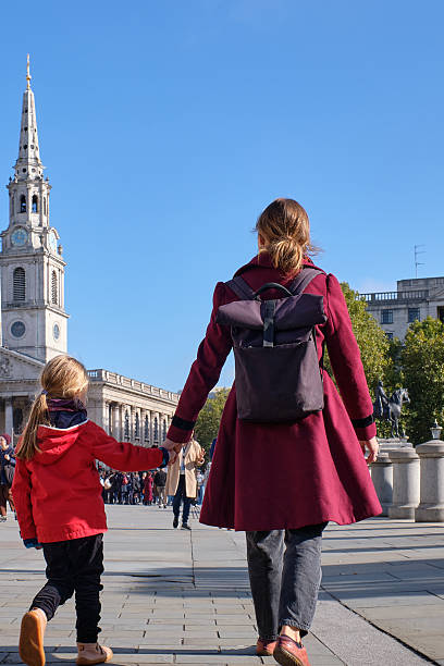 istock Mother and Daughter Holding Hands While Exploring Trafalgar Square in London 2216609092