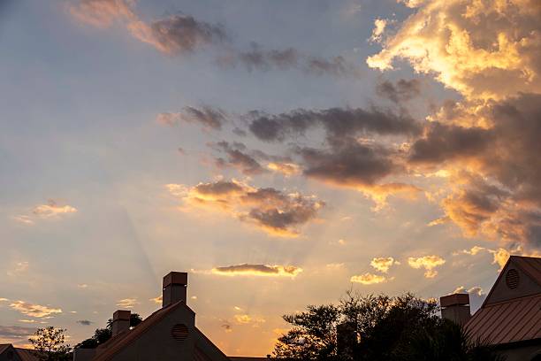 istock A sunset casts vibrant colors over charming houses with chimneys 2216609438