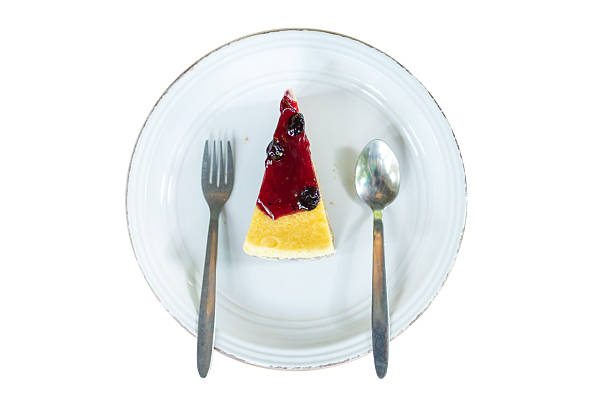 Die cut of Blueberry Cheesecake in the plate on white isolated.