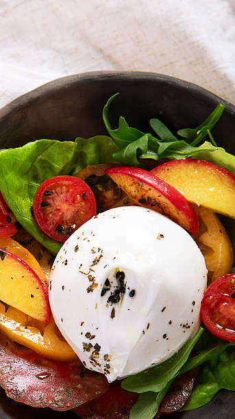 istock Salad with burrata cheese, lettuce and tomatoes 2216610292