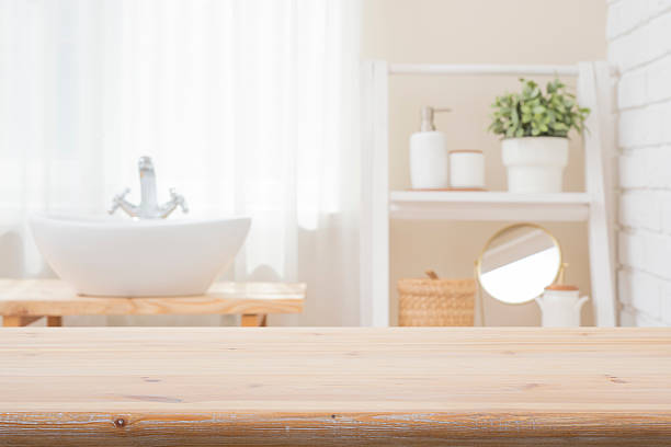 istock Bleached wood table top for product montage on blurred bathroom window and shelf interior background 2216617324