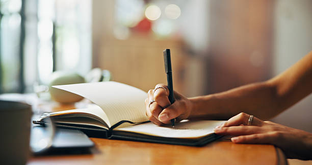 istock Home, writer and hands with notebook for writing, schedule or daily reflection for wellness. Closeup, person and student with journal for assessment reminder, to do list or thoughts for mental health 2216618948