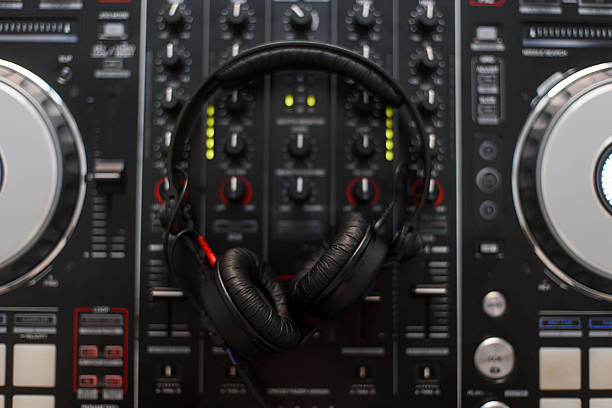 A close-up view of a professional audio mixing console featuring numerous knobs, buttons, and sliders. The detailed interface showcases the complexity of sound engineering equipment used in music production and broadcasting. The red and gray controls create a striking contrast, emphasizing precision and functionality.
