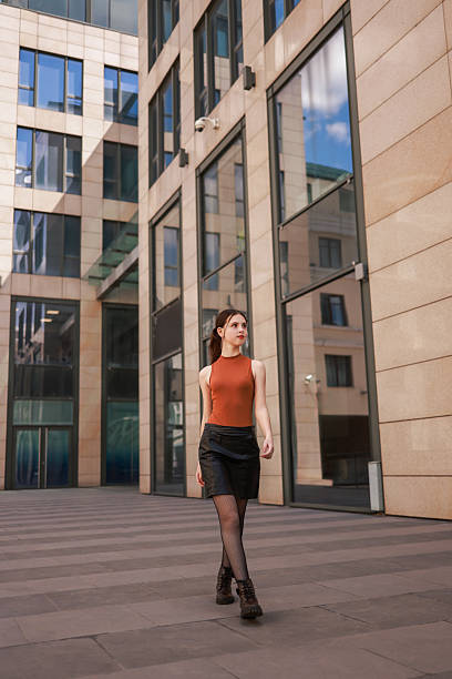 istock A girl walks through a modern city. 2216621727