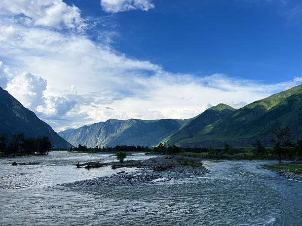 istock Serene mountain landscape with river flowing through green valley under blue sky 2216622073