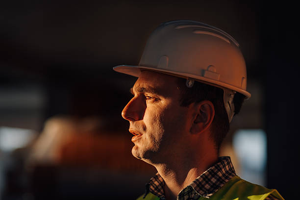 istock Supervisor wearing hardhat inspecting construction site at sunset 2216624512