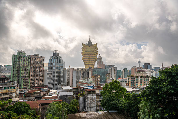 istock Panoramic view from Monte Fort in Macau, showcasing historic stone walls, lush greenery, and iconic Grand Lisboa 2216624676