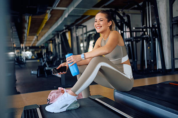 istock Happy athletic woman having water break while working out in a gym. 2216625101