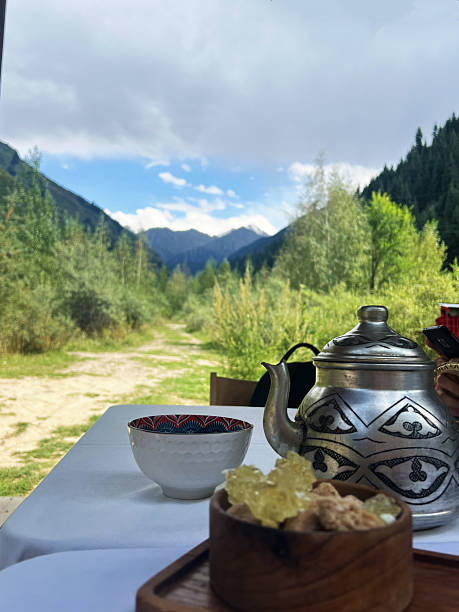 istock Serene mountain landscape with traditional tea set and pathway under cloudy sky 2216625119