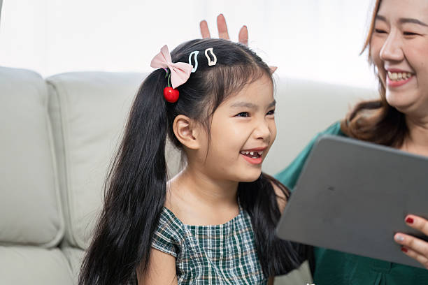 istock Back to School and Family Bonding. A mother and daughter share laughter while learning with a tablet. 2216627677