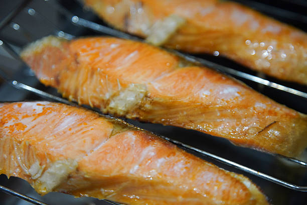 Grilling salmon on a fish grill