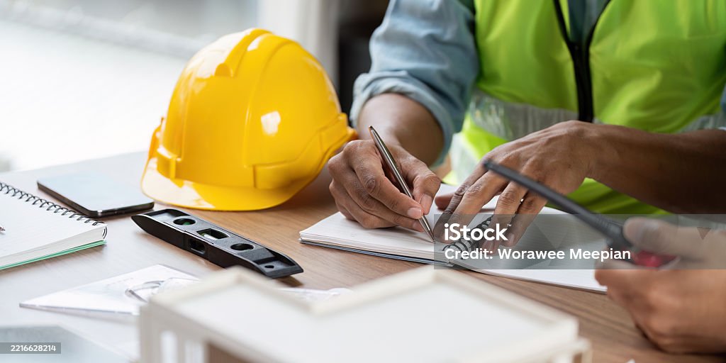 Engineering Safety Practice Green Tech Safety Practices With Engineers Writing In Notebook Stock ...
