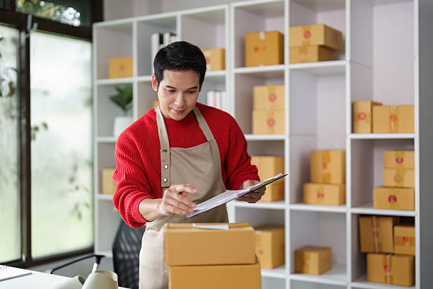istock Small business owner managing orders and inventory in office 2216629656