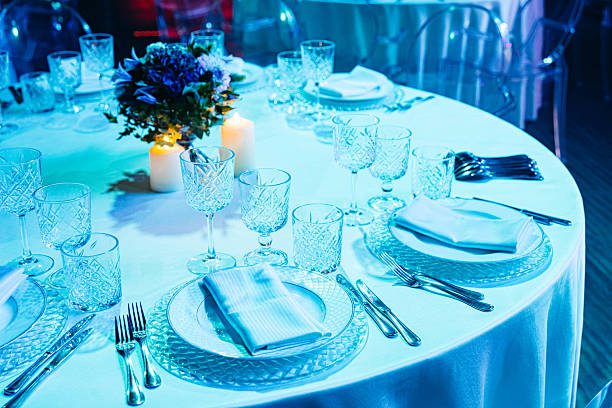 istock Elegant event table setup with candles and glassware. 2216629909