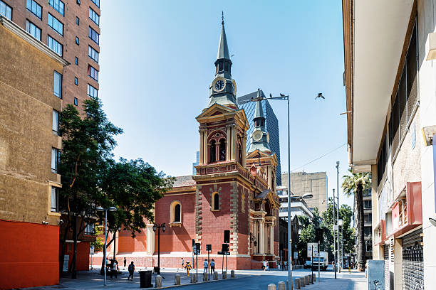 Iconic Mirador Massue in Buenos Aires, with its Art Nouveau tower standing out against a modern glass building and a vibrant sunset. Located in front of the historic Palace of Justice.