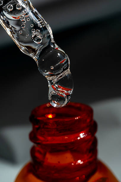 istock A drop of cosmetic aromatic oil drips from the pipette. Front view. 2216632816