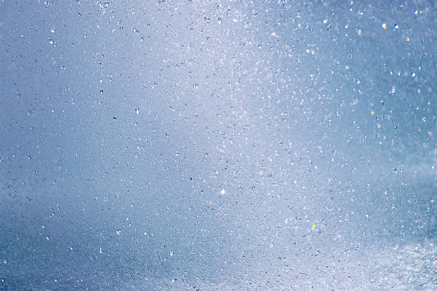 istock Cascading water droplets in motion against a clear sky 2216635445