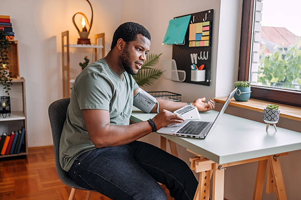 istock People checking their health at home using devices connected with laptop 2216636591