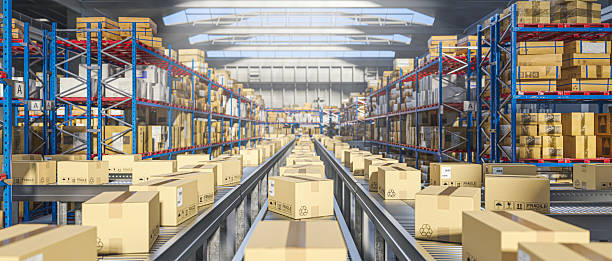 istock Cardboard boxes moving on conveyor belt in distribution warehouse 2216637106