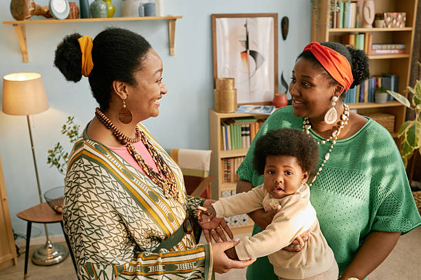 istock Two Black Women Chatting while Holding Baby at Home 2216640691