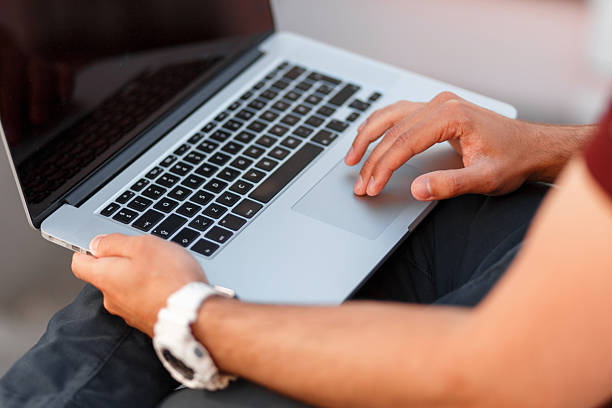 istock Blogger man with laptop working. Close-up 2216644129