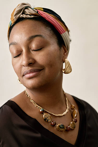 istock Woman Wearing Jewelry and Head Wrap Posing in Studio 2216644892