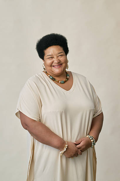 istock Smiling Black Woman in Neutral Outfit Posing in Studio 2216644906