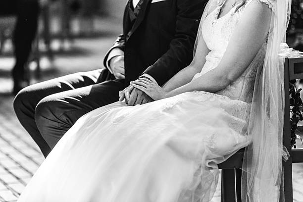 asian wedding couple hugging each other, focus on the bouquet, black and white.