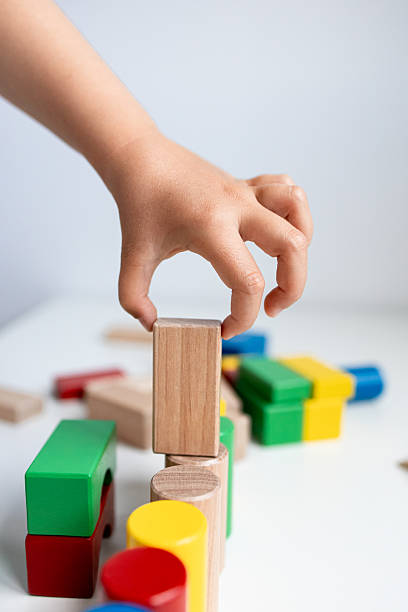 istock Child playing with colorful wooden blocks 2216646481