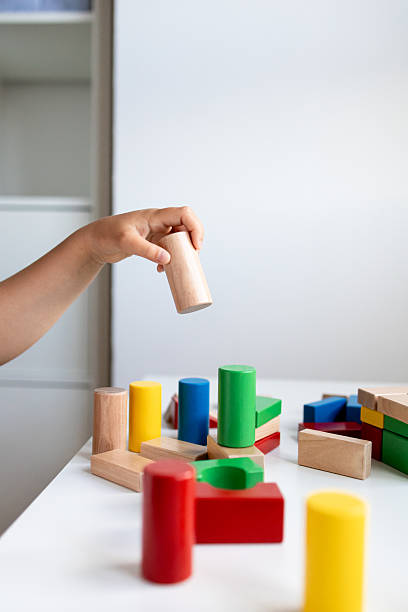 istock Child engaging with colorful wooden blocks for hands on play and learning 2216646497