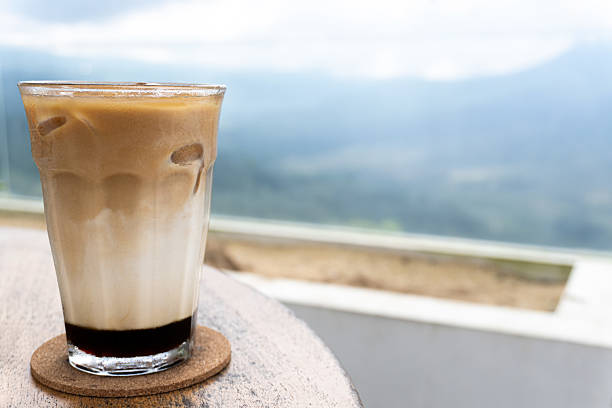Iced Latte Vista Coffee break overlooking serene mountain landscape.