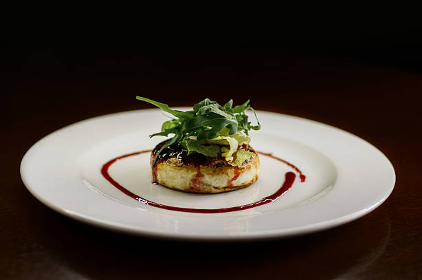 istock Tasty cheese pancake with greens on a plate on a dark background 2216650649