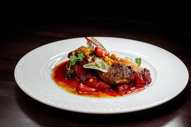 istock Delicious meat dinner with vegetables on a wooden dark table 2216650704