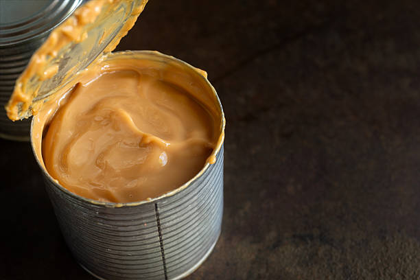 istock Fresh dulce de leche made from canned condensed milk on rustic table 2216652245